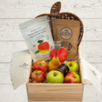 Box with apples, peans, caramel and nuts