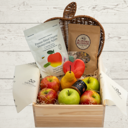 Box with apples, peans, caramel and nuts