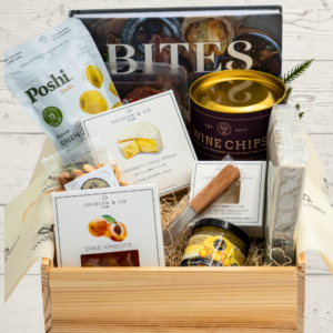 Charcuterie box with a book and food items