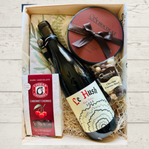 A bottle of wine and chocolate items in box