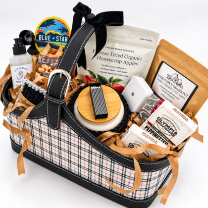basket filled with coffee, apples, candle and other things