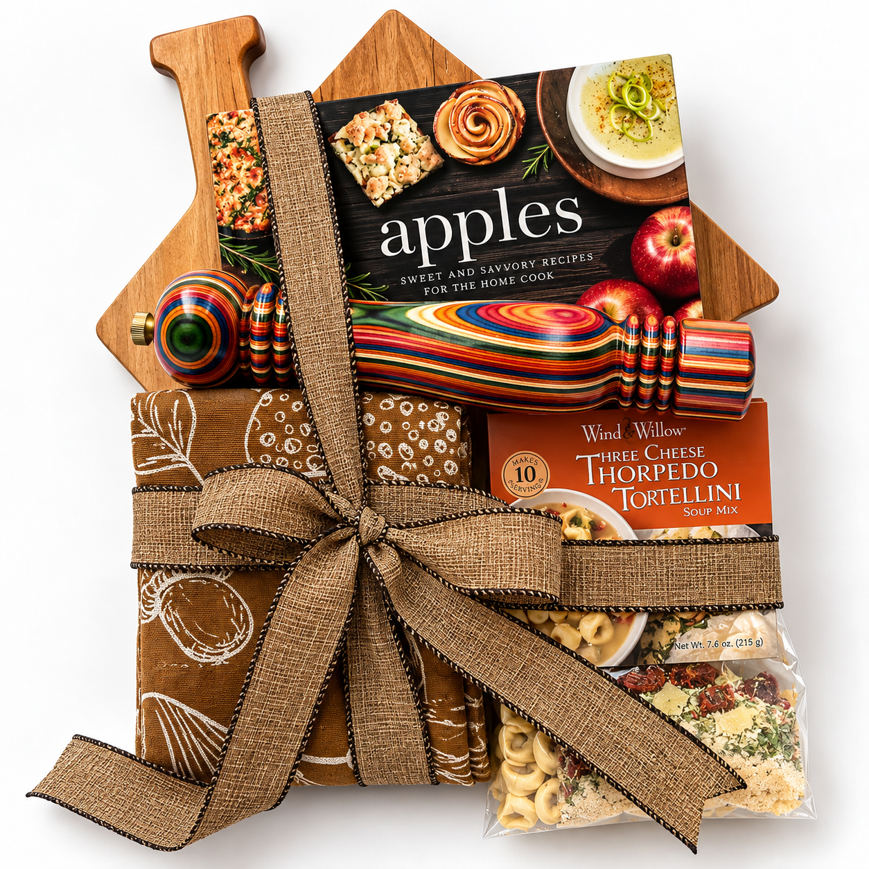 House shaped board with pepper mill apple cookboox and kitchen towels
